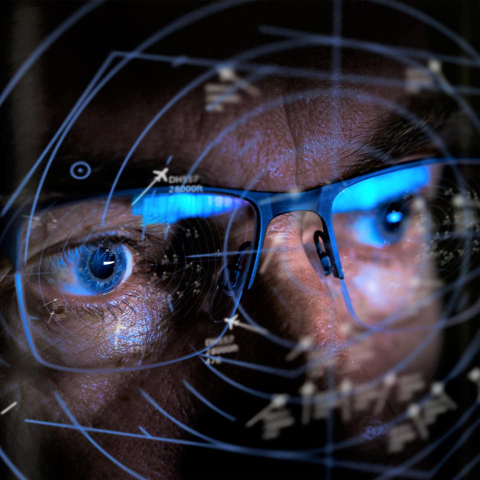 Man in glasses looking at air traffic on clear monitor. Man in glasses looking at air traffic on clear monitor.