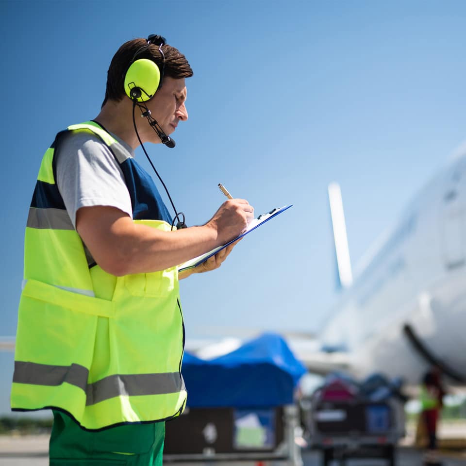ATC Clipboard Air traffic controller writing on clipboard outside.